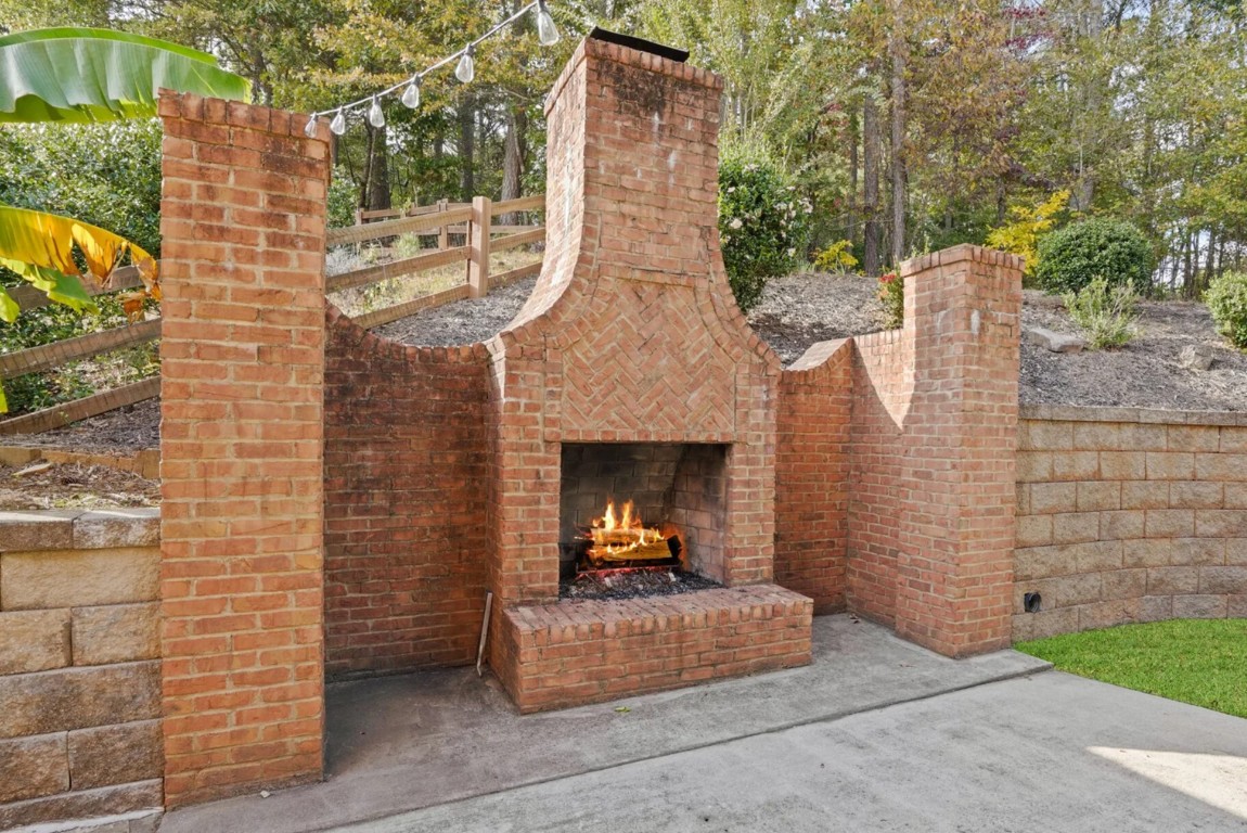 Custom brick outdoor fireplace and masonry work in residential backyard