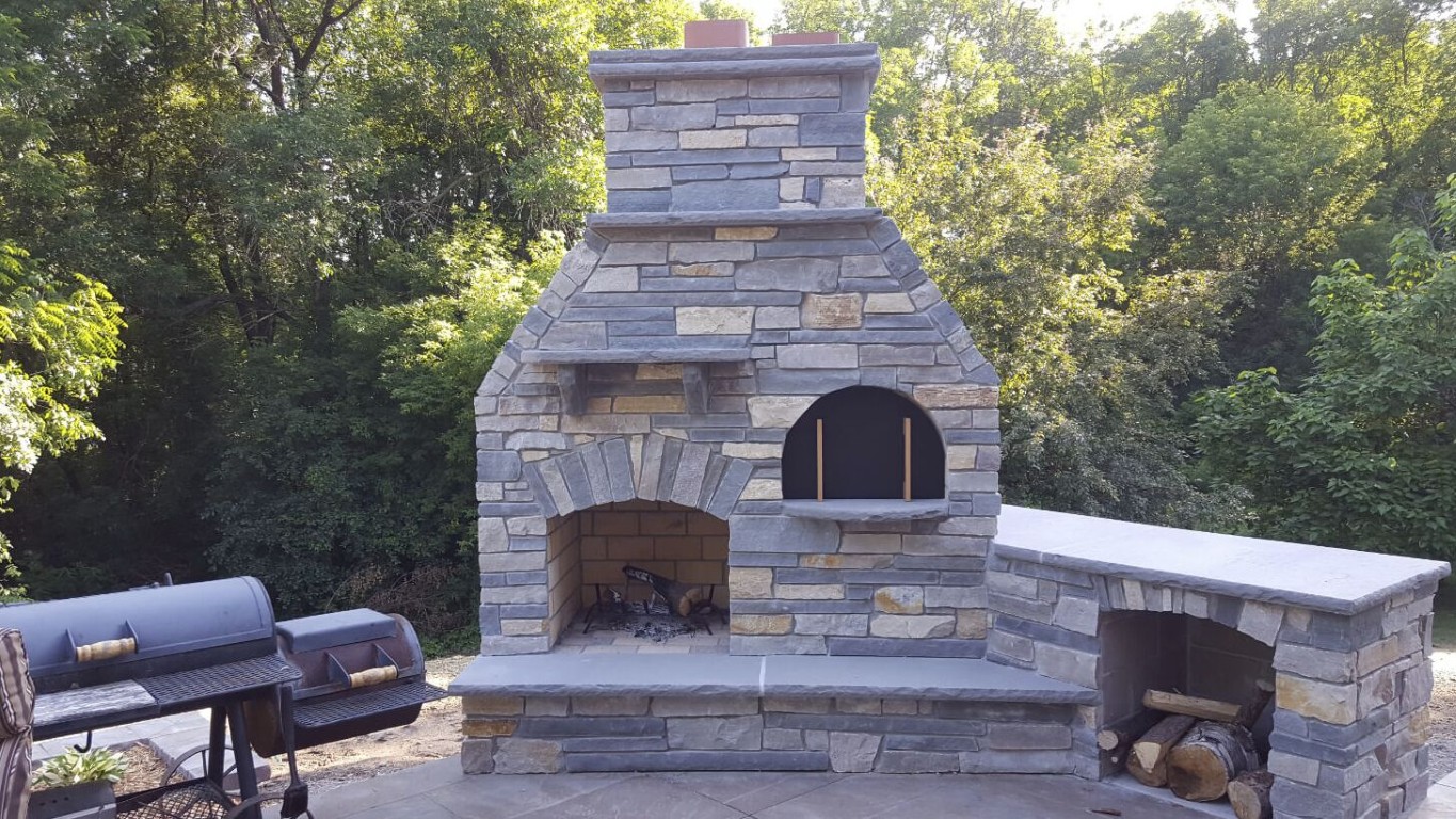 Custom outdoor stone fireplace and pizza oven built by masonry contractors in Temecula, CA